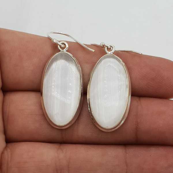 Silver drop earrings set with oval-shaped Selenite