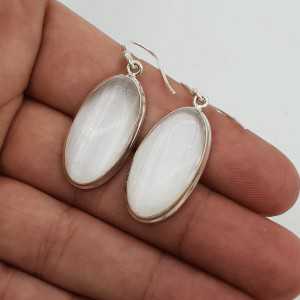 Silver drop earrings set with oval-shaped Selenite