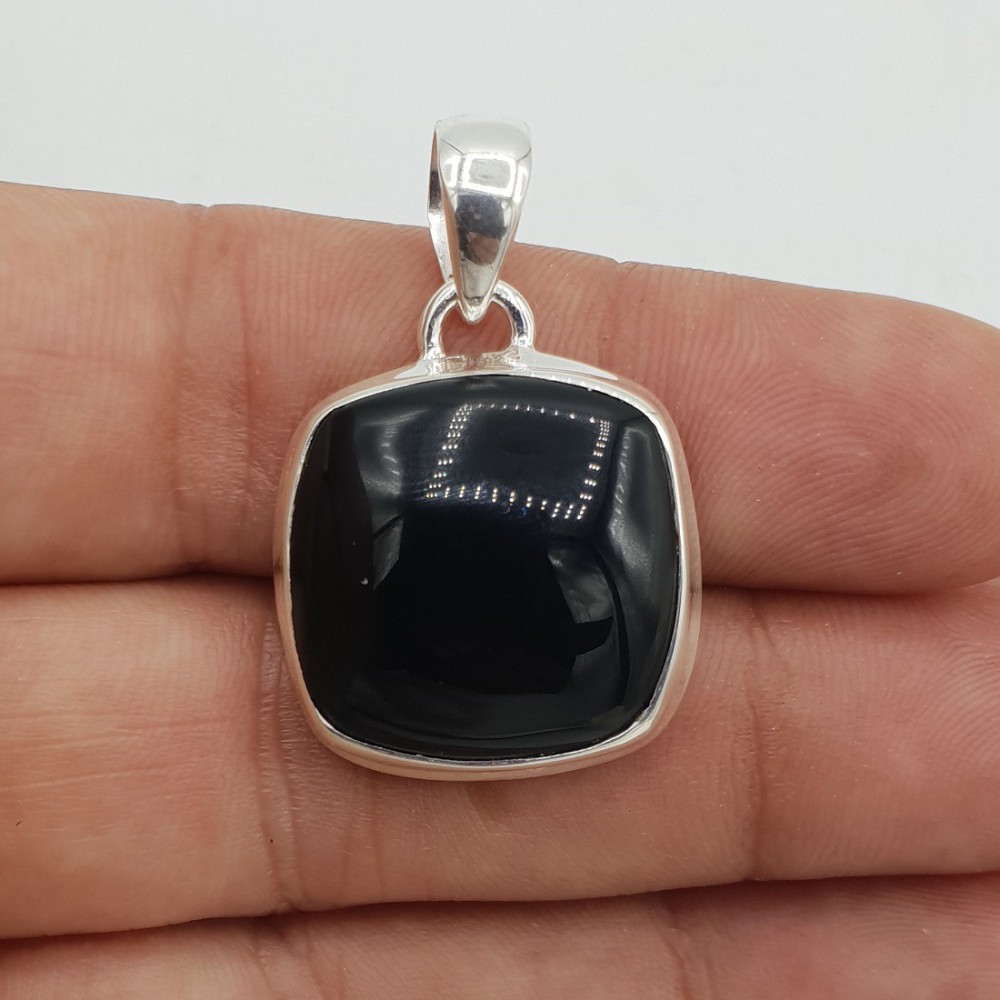 A silver pendant set with a square cabochon of black Onyx.