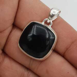 A silver pendant set with a square cabochon of black Onyx.