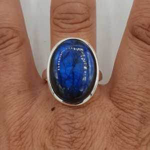 A silver ring set with large oval-shaped Labradorite is 21 mm