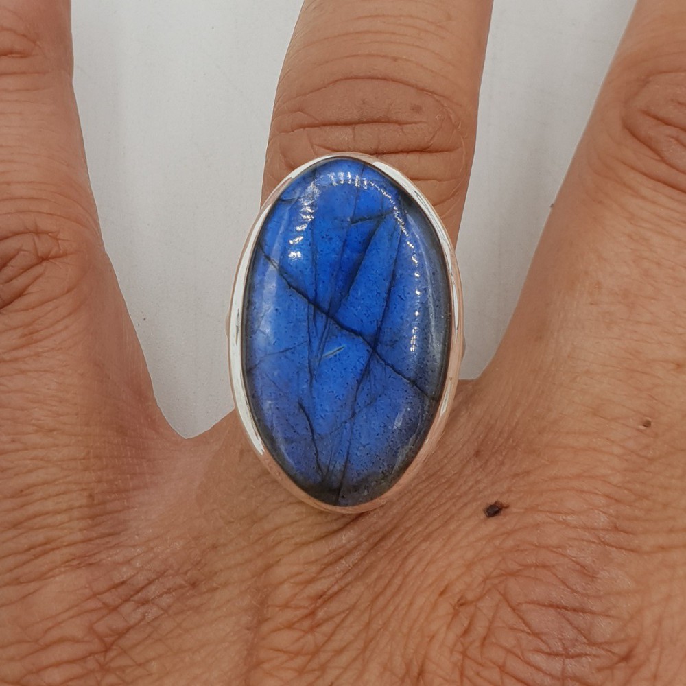 A silver ring set with an oval cabochon Labradorite is 17 mm