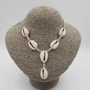 A silver necklace with a Cowrie shell