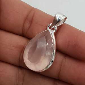 A silver pendant set with a large oval facet cut rose quartz