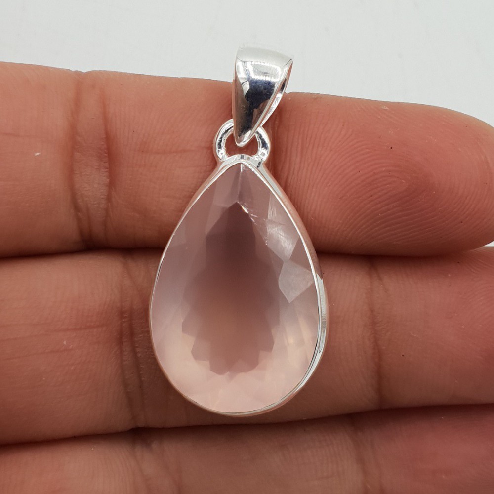 A silver pendant set with a large oval facet cut rose quartz