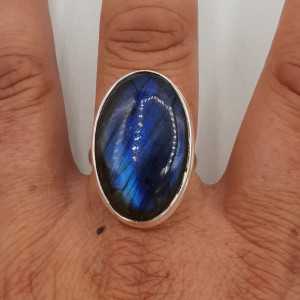 A silver ring set with an oval cabochon cut Labradorite 17.7 mm