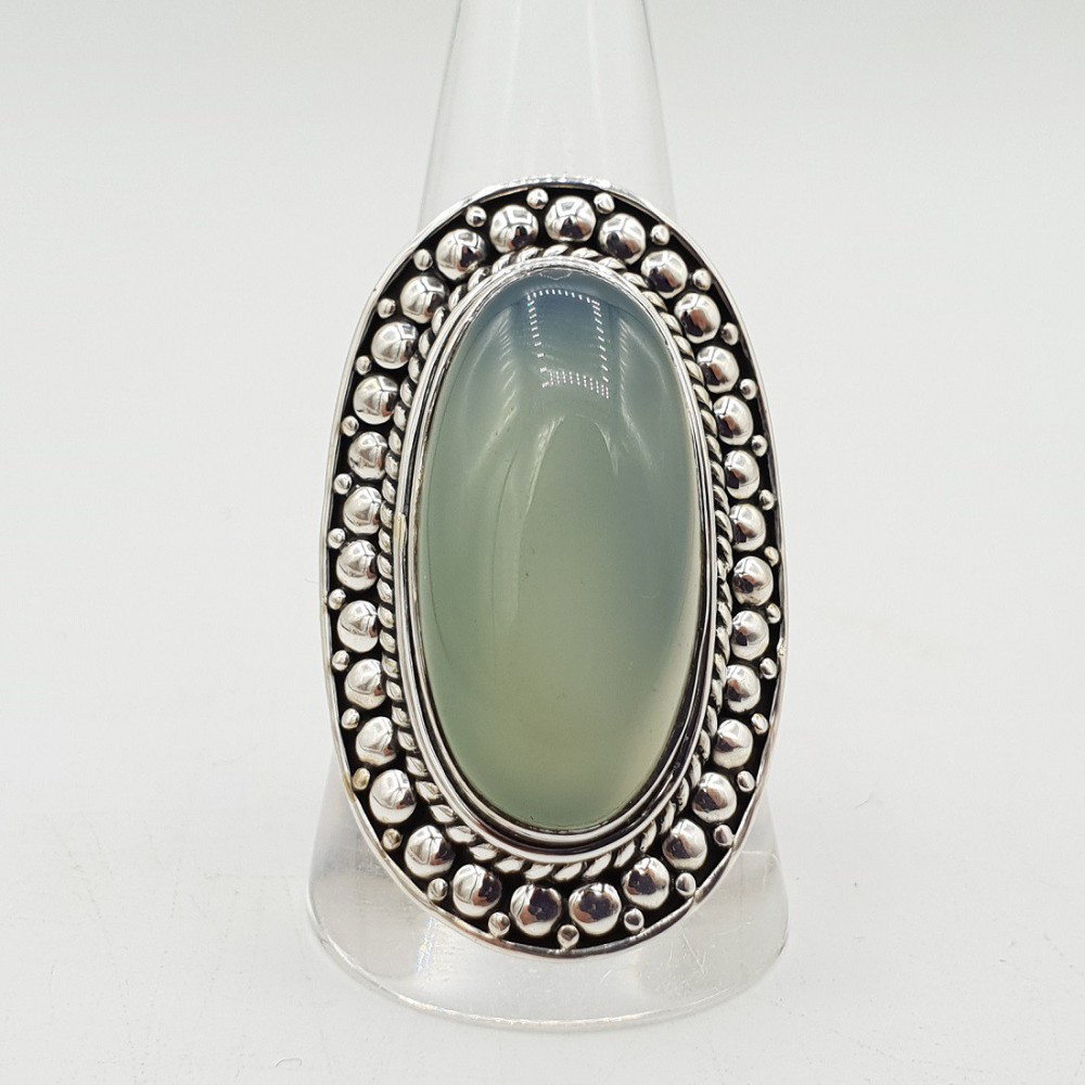 A silver ring set with an oval aqua Chalcedony