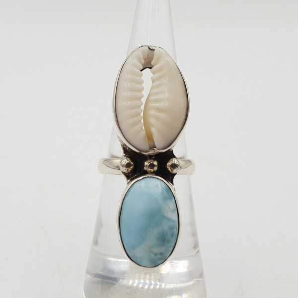 A silver ring set with a Cowrie shell and Larimar 16mm