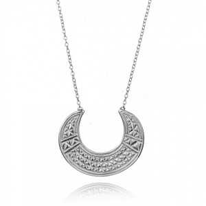 A silver necklace with a crescent moon carved pendant