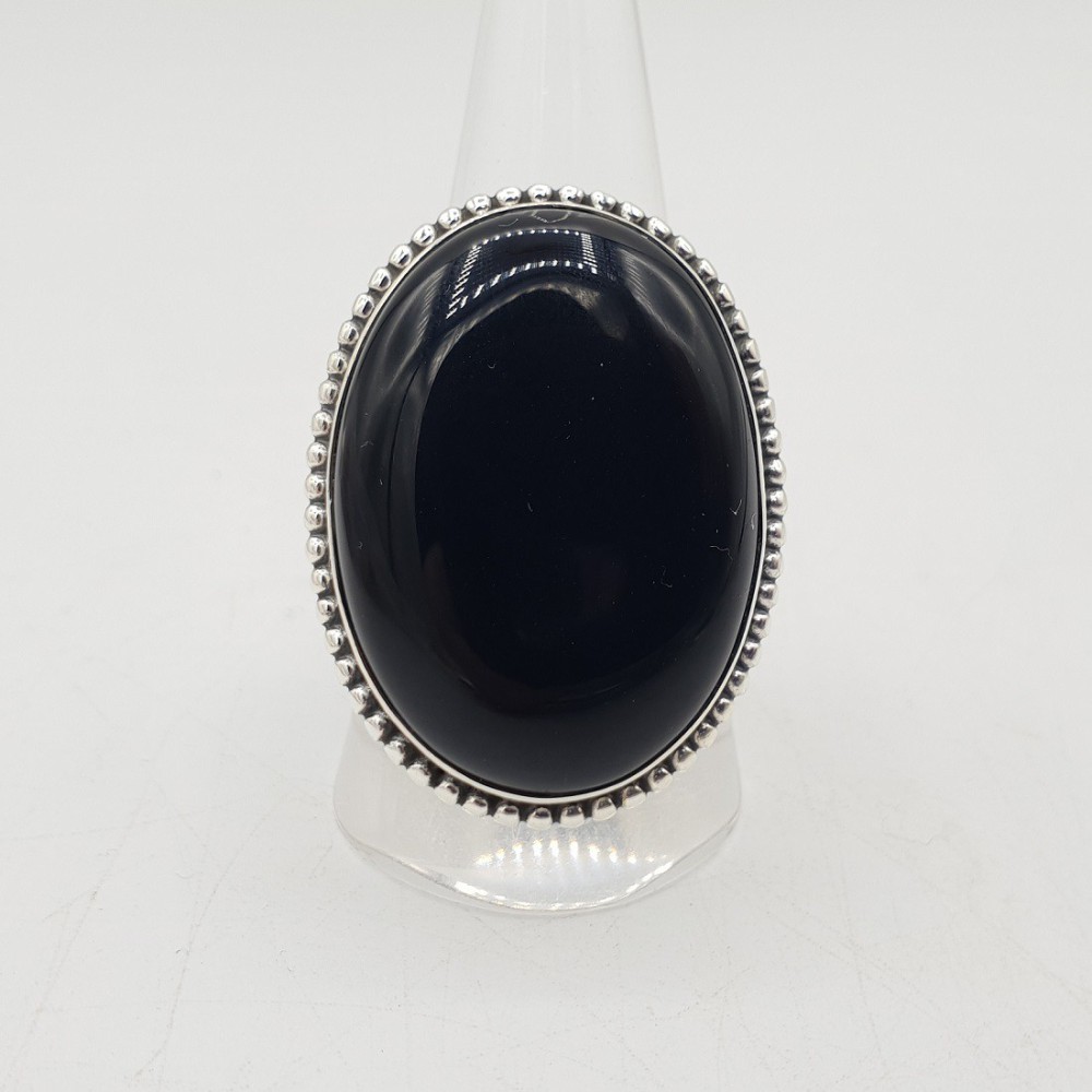 A silver ring set with a large oval-shaped black Onyx 19.5 mm