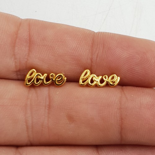 Vergulde love oorknoppen