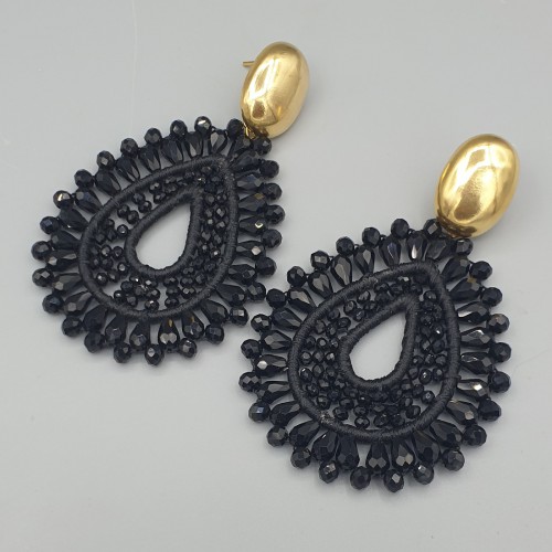 Vergulde oorbellen met zwarte druppelvormige hanger