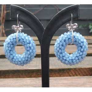 Silver earrings with round pendant of light blue Crystals