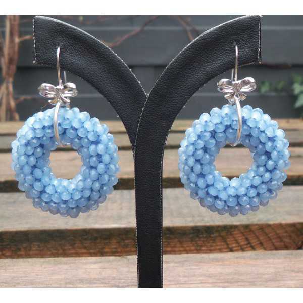 Silver earrings with round pendant of light blue Crystals